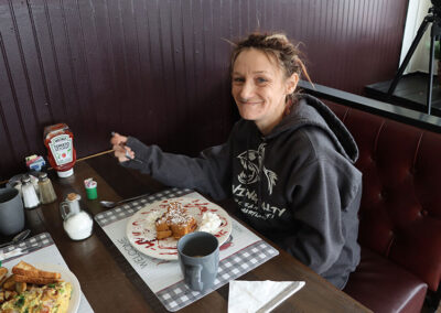 Smiling woman eating stuffed French toast