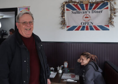 Man Smiling by Sullivans Diner Sign